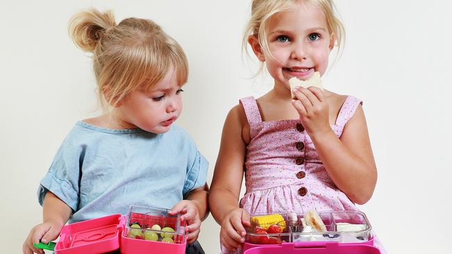 Alenna Matthews, 4, and her sister Eden, 2, tuck into their healthy lunch boxes. Photo: Claudia Baxter