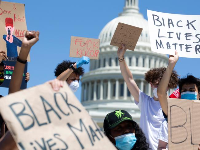 Demonstrators hold up their signs by Capitol Hill, Washington, D.C. Picture: AFP