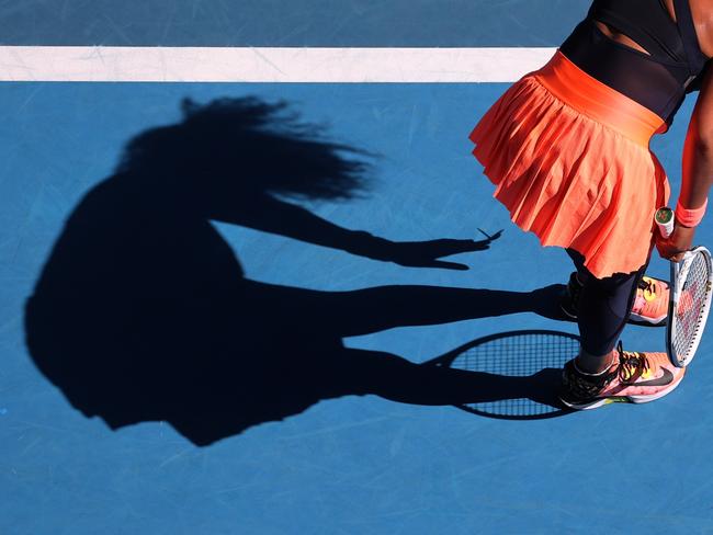 EMBARGO FOR TWAM 21 JANUARY 2023. FEE MAY APPLY.  Japan's Naomi Osaka removes a butterfly from her dress as she plays against Tunisia's Ons Jabeur during their women's singles match on day five of the Australian Open tennis tournament in Melbourne on February 12, 2021.