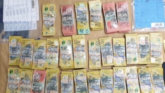 Campsie police allegedly seizing more than $1m in cash and ammunition from a home in Revesby. Picture: NSW Police