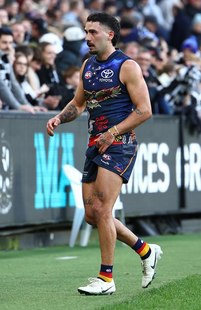 Izak Rankine of the Crows walks off the field after injuring his hamstring during his sprint down the MCG wing. Picture: Quinn Rooney/Getty Images.