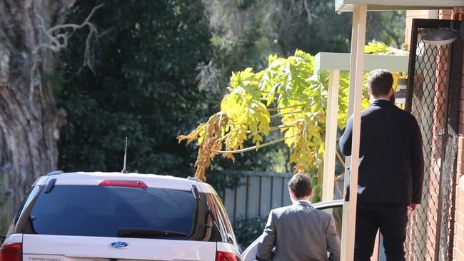 Men knock on the door of the unit in Renown Ave, Wiley Park. Picture: John Grainger