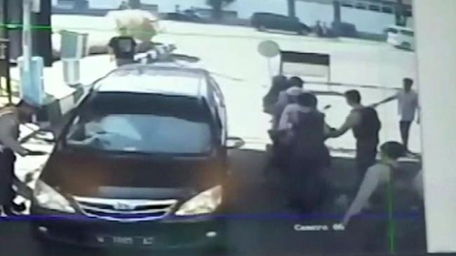 CCTV footage of two motorbikes, right, carrying five members of a family moments before they detonate explosives as they enter police headquarters in Surabaya yesterday.