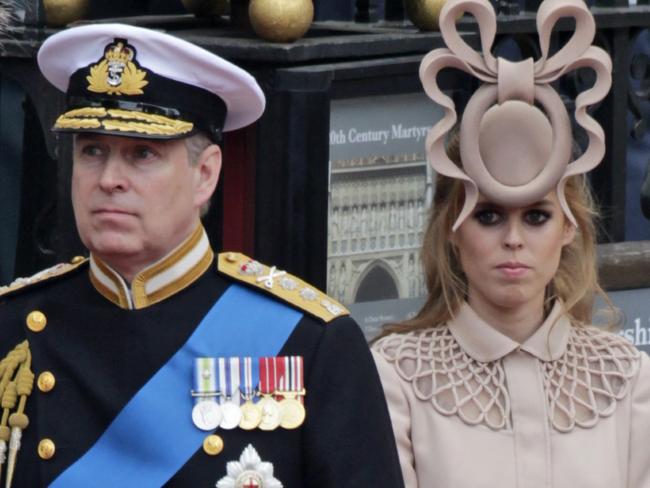 29/04/2011 WIRE: FILE - In this Friday, April, 29, 2011 file picture Britain's Prince Andrew, left, and his daughter Britain's Princess Beatrice leave Westminster Abbey at the Royal Wedding in London. Online auctioneer eBay says that bids for one of the wackiest pieces of royal wedding headgear have approached 18,400 pounds ($30,000.) Princess Beatrice's massive, ring-and-bow-shaped hat, turned heads at the wedding of her cousin Prince William last month and has since become an Internet sensation. The Philip Treacy creation has been compared to a toilet seat or a pretzel, and has been endlessly photoshopped to feature, for example, a cat crawling through it. (AP Photo/Gero Breloer)