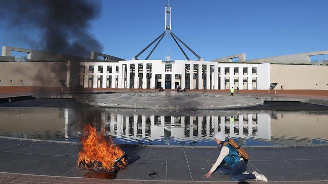 Extinction Rebellion protesters lit up a baby's pram outside Parliament House. Picture: NCA NewsWire/Gary Ramage