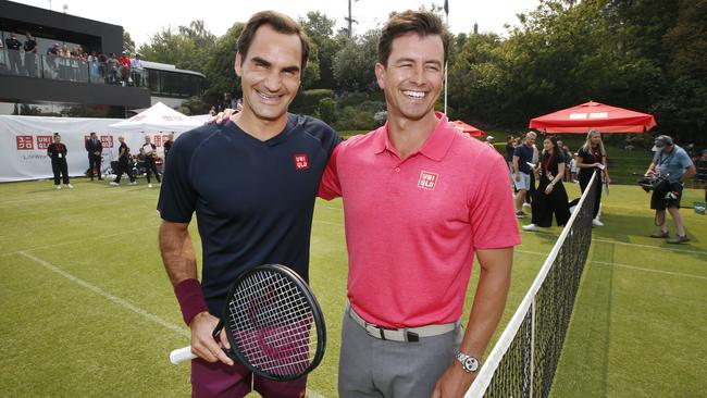 Roger Federer, with Australian golfer Adam Scott at a sponsor’s event at South Yarra tennis club, has had a laid-back preparation for the Australian Open. Picture: David Caird