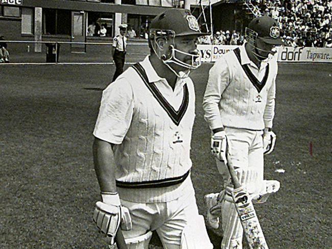 David Boon, left, and Mark Taylor walk out to start the first ever cricket Test in Hobart.