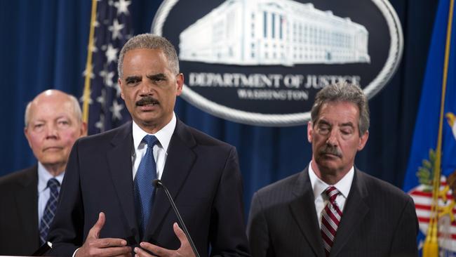 Attorney General Eric Holder, middle, outlines the charges brought against Credit Suisse.