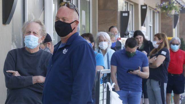 People line up to enter a meat works in the US.