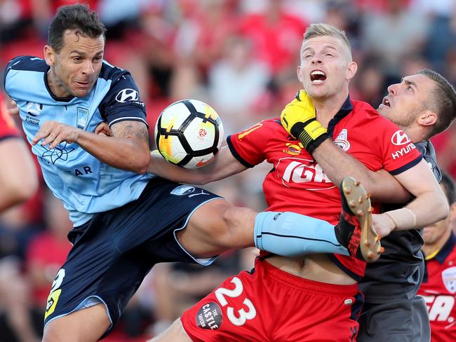 Sydney FC striker Bobo clashes with Adelaide’s Jordan Elsey. Picture: AAP