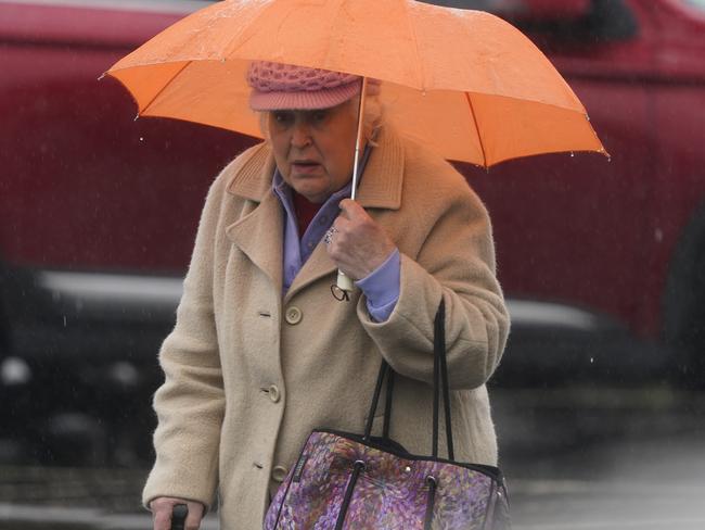 Friends and loved ones braved the rain to attend the service. Picture: Valeriu Campan