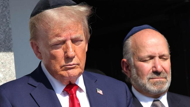 NEW YORK, NEW YORK - OCTOBER 07: Republican presidential nominee, former U.S. President Donald Trump, prays at Ohel Chabad Lubavitch on October 07, 2024 in New York City. Trump commemorated the one-year anniversary of October 7th by visiting to Ohel Chabad Lubavitch, the final resting place of Rabbi Menachem M. Schneerson the Rebbe, with the family of Edan Alexander, who was taken hostage by Hamas on October 7th, in attendance. On October 7, the Palestinian militant group Hamas launched a surprise attack on Israel from Gaza by land, sea, and air, killing more than 1,200 people and taking Israeli soldiers and civilians hostage. To date, there are over 90 people still being held hostage by Hamas.   Michael M. Santiago/Getty Images/AFP (Photo by Michael M. Santiago / GETTY IMAGES NORTH AMERICA / Getty Images via AFP)