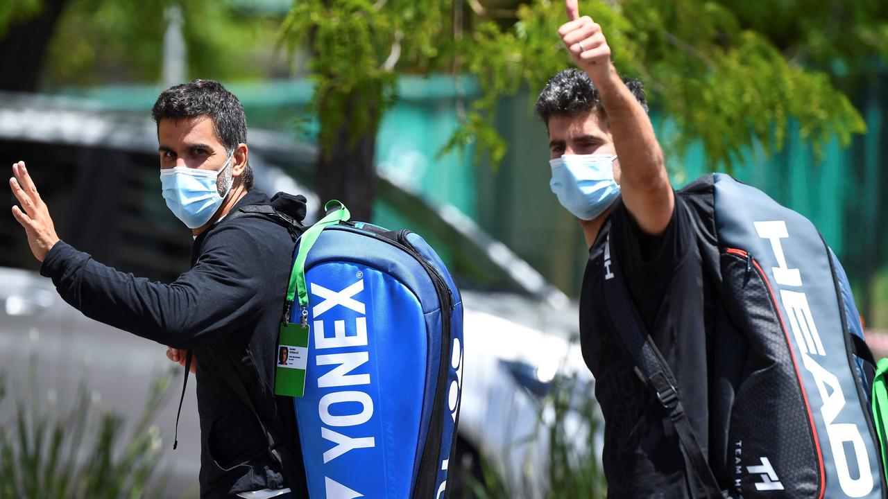 Argentine tennis player Maximo Gonzalez, left, and Italy's Simone Bolelli return to a hotel after a training session in Melbourne on January 18, 2021. Picture: William West/AFP