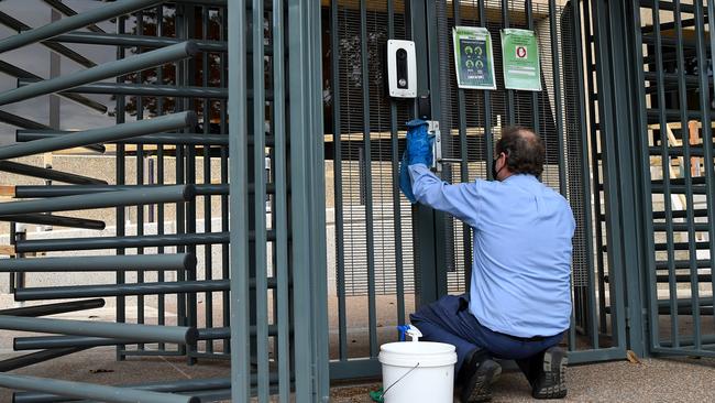 A cleaner disinfects the rear entrance gates a Parliament House in Sydney. Picture: NCA NewsWire/Joel Carrett