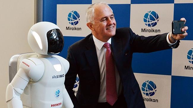 Prime Minister Malcolm Turnbull takes a selfie with Japanese auto giant Honda Motor's humanoid robot Asimo.