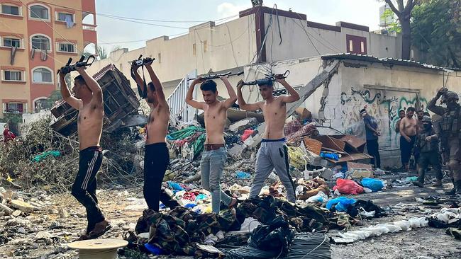 This picture released by the Israeli army shows Palestinian fighters holding weapons above their heads near the Kamal Adwan hospital. Picture: AFP/Israeli Army