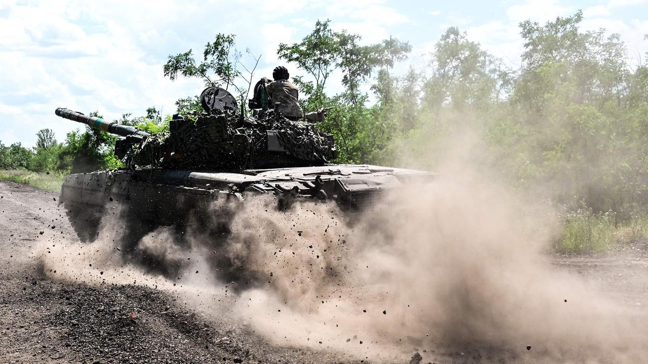 Ukrainian servicemen drive a T-72 tank on the frontline in eastern Ukraine. Picture: Miguel Medina/AFP