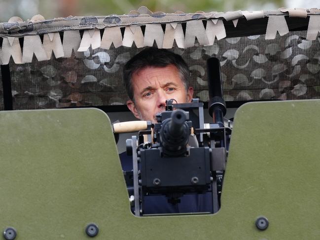 King Frederik X of Denmark peeks out of the turret on the top of the Patria 6x6 vehicle as he visits the main base of the Coastal Brigade in Upinniemi, Kirkkonummi, Finland, on March 5, 2025. (Photo by Ida Marie Odgaard / Ritzau Scanpix / AFP) / Denmark OUT