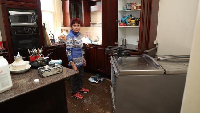 Narelle Frost helps clean-up iconic home ‘Bridgeview’ opposite the Windsor Bridge. This is the third time this year it has been inundated, and locals say it is in dire need of heritage listing and funding. Picture: John Grainger