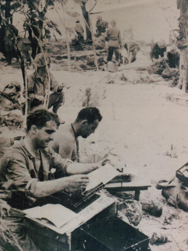 Denis Warner (in foreground with his trusty Remington typewriter), on beach at Saipan on day two of the US landing, June 1944