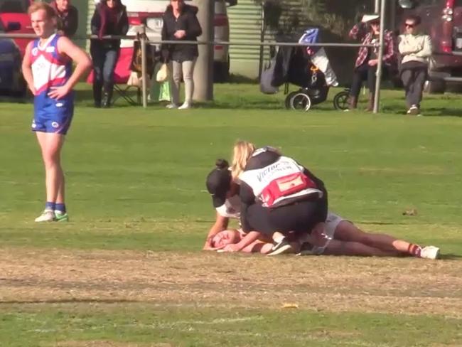 Trainers attend to Tim Duckworth on the ground.