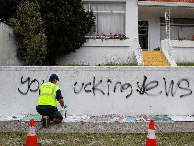 SYDNEY, AUSTRALIA : NewsWire Photos - JANUARY 30 2025; A council worker is seen working to remove the grafitti at a house next door to the Mount Sinai College in Maroubra as new anti-semitic graffiti plastered on property at in Sydney continues to suffer a spate of anti semitic attacks. Picture: NewsWire/ Gaye Gerard