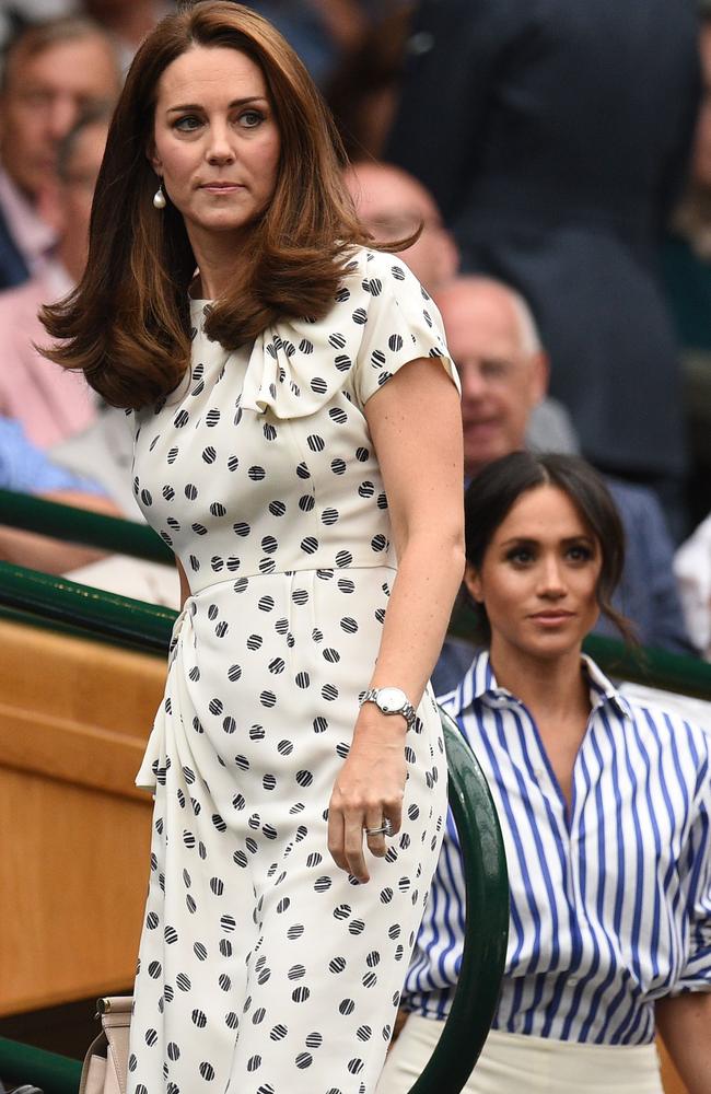 Keen tennis fan Kate rocked a black and white dress as she swapped words with a junior player. Picture: AFP/ Oli Scarff.