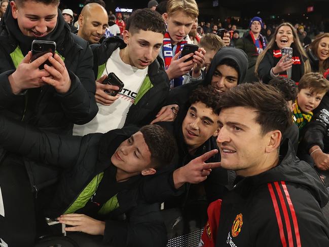 MELBOURNE, AUSTRALIA - JULY 19: Harry Maguire of Manchester United signs autographs after the Pre-Season Friendly match between Manchester United and Crystal Palace at Melbourne Cricket Ground on July 19, 2022 in Melbourne, Australia. (Photo by Robert Cianflone/Getty Images)