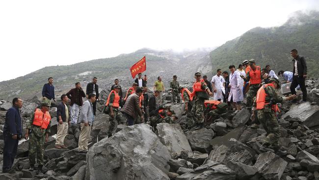 Emergency personnel work at the site of a landslide in Xinmo village in Maoxian County in southwestern China's Sichuan Province, Saturday, June 24, 2017. Around 100 people are feared buried by a landslide that unleashed huge rocks and a mass of earth that crashed into their homes Saturday, a county government said. Picture: He Qinghai/Xinhua via AP.