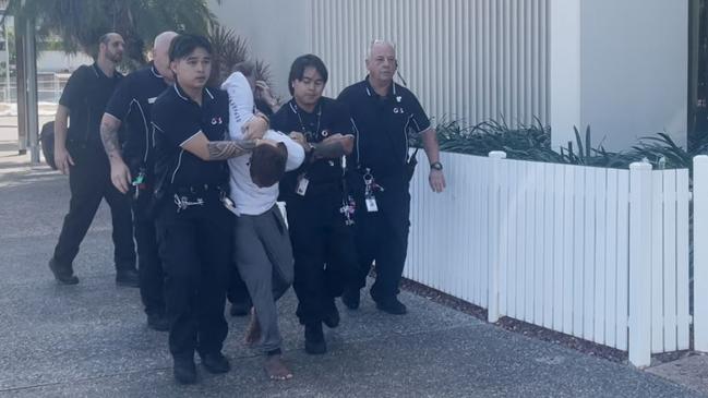 Ezra Austral was restrained by security after evading G4S court security, jumping over the barrier and running down the street at Darwin Local Court on Thursday, May 29. Picture: Zizi Averill