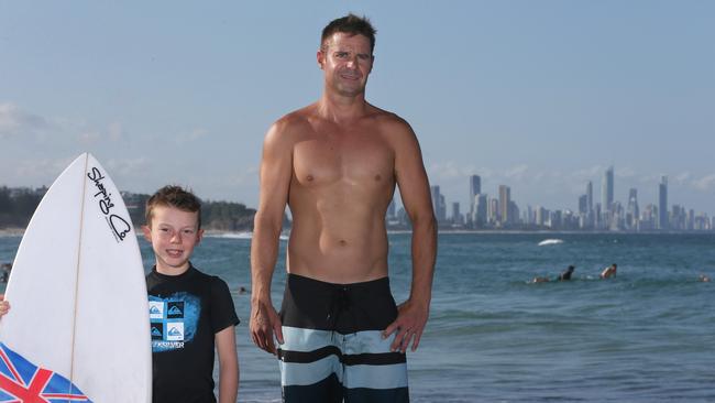 Seth Michell, 8, and dad Steve Michell after spending a weekend surfing at Burleigh, Gold Coast. To go with story for support to push the Gold Coast to be declared a world surfing reserve. Picture: Regi Varghese