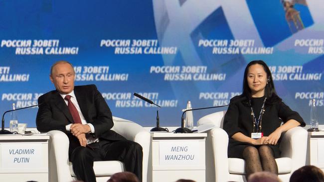 Russia's President Vladimir Putin and Meng Wanzhou, Executive Board Director of the Chinese technology giant Huawei, at a conference in 2014.