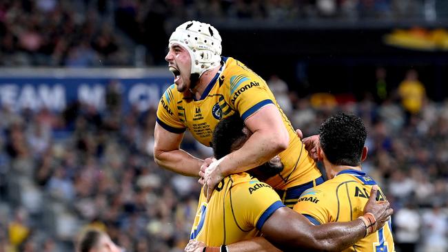 Maika Sivo of the Eels celebrates a try with teammates Bailey Simonsson and Reed Mahoney during the NRL Preliminary Final match between the North Queensland Cowboys and the Parramatta Eels. (Photo by Bradley Kanaris/Getty Images)