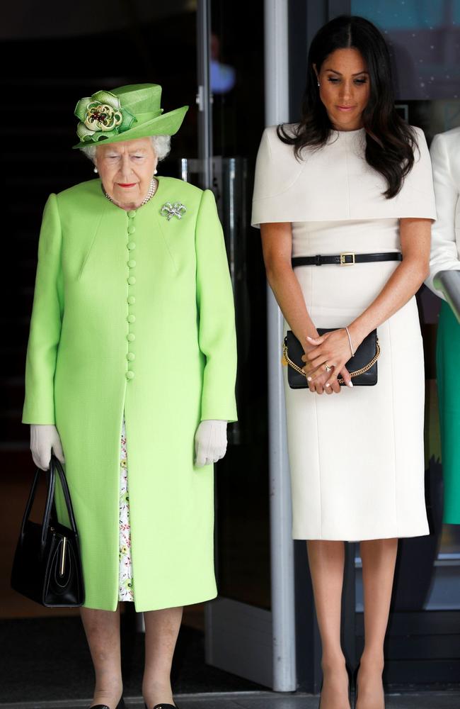 Britain's Queen Elizabeth II and Britain's Meghan Markle, Duchess of Sussex observe a moment of silence in memory of the victims of the Grenfell Tower fire. Picture: AFP