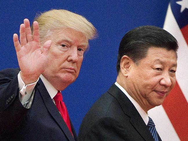 (FILES) This file photo taken on November 08, 2017 shows US President Donald Trump (L) and China's President Xi Jinping leaving a business leaders event at the Great Hall of the People in Beijing. - The new partial trade agreement between the United States and China will be signed in the middle of next month in Washington, US President Donald Trump said on December 31, 2019. "I will be signing our very large and comprehensive Phase One Trade Deal with China on January 15," Trump tweeted moments before Wall Street was due to open. "The ceremony will take place at the White House. High level representatives of China will be present." Trump said he would then travel to Beijing to continue negotiations "at a later date." (Photo by Nicolas ASFOURI / AFP)