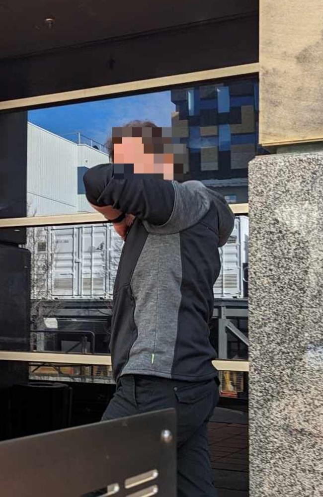 The man tried to cover his face as he left court on Friday.