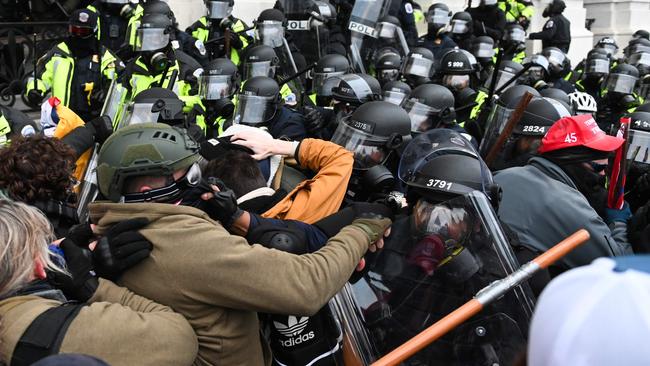 Trump supporters clash with police outside the Capitol building.