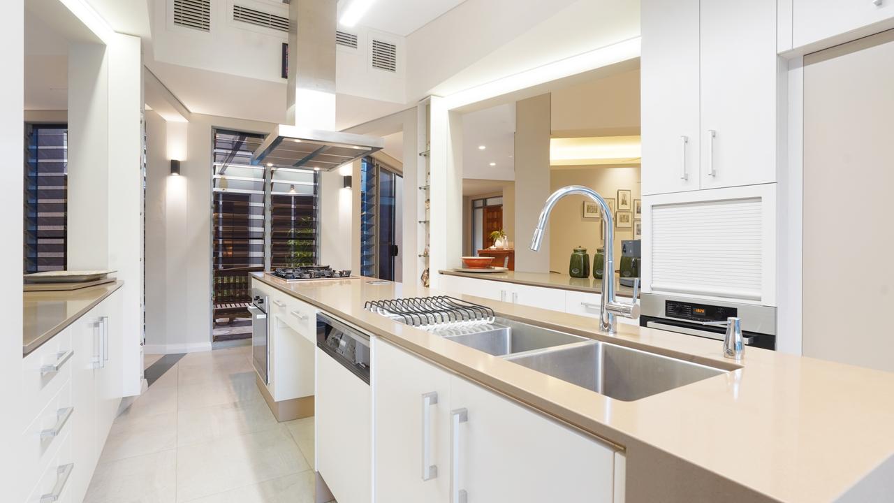 The modern kitchen features sleek stone and stainless steel appliances. Picture: Supplied