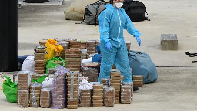 Police remove a large amount of methamphetamine from a yacht docked at Balmain on Sunday. Picture: AAP