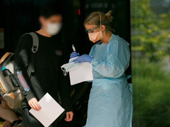 Patient in mask been seen by triage nurse at Northern Beaches Hospital's new COVID-19 clinic. Picture: Tim Pascoe.