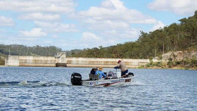 FRESH STOCKS: Members of the fish stocking association prepare to release Australian Bass fingerlings on the far side of Lake Manchester. Picture: Contributed