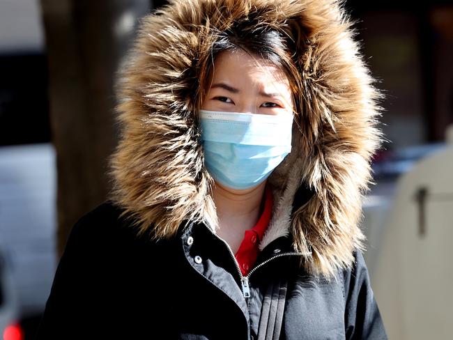 SYDNEY, AUSTRALIA - NCA NewsWire Photos JULY, 29, 2020: A woman walks on Liverpool Street wearing a mask and a parka. in Sydney. Picture: NCA NewsWire / Dylan Coker