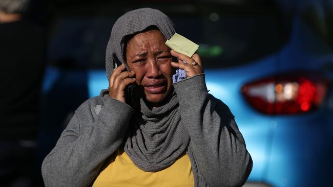 A woman cries as she tries to locate a missing relative. Picture: AFP