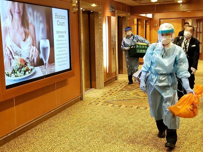 This handout photo released to AFP via Twitter handle @DAXA_TW on February 4, 2020 shows officials in masks and protective clothing on one of the decks of the Diamond Princess cruise ship, as the vessel carrying 3,711 people sits in the port of Yokohama. - At least 10 people on the cruise ship quarantined off the coast of Japan have tested positive for the new coronavirus, Japan's health minister said on February 5. (Photo by Handout / Twitter handle @DAXA_TW / AFP) / EDITORS NOTE: THE FACES HAVE BEEN PIXELATED DUE TO SOURCE -----EDITORS NOTE --- RESTRICTED TO EDITORIAL USE - MANDATORY CREDIT "AFP PHOTO / Twitter handle @DAXA_TW" - NO MARKETING - NO ADVERTISING CAMPAIGNS - DISTRIBUTED AS A SERVICE TO CLIENTS  - NO ARCHIVES /