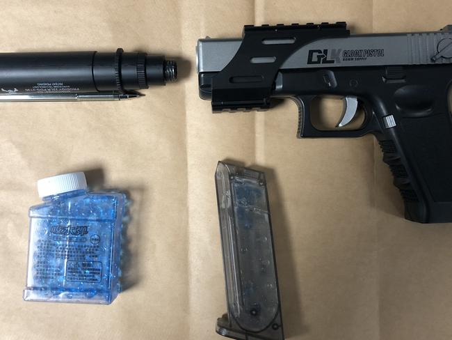 A Glock-18 replica 'Gel Blaster' pistol, along with a silencer and 'ammunition', seized from a man by Northern Beaches Police after receiving a triple zero call from a member of the public reporting seeing a man with a gun at a popular beach lookout. Picture: NSW Police