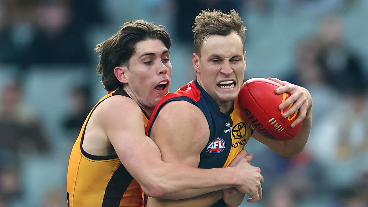 MELBOURNE, AUSTRALIA - JUNE 01: Jordan Dawson of the Crows is tackled by Will Day of the Hawks during the round 12 AFL match between Hawthorn Hawks and Adelaide Crows at Melbourne Cricket Ground, on June 01, 2024, in Melbourne, Australia. (Photo by Quinn Rooney/Getty Images)