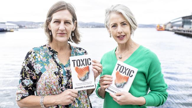 Following the Launch of Richard Flanagan's book Toxic, fishers, sailors, community and environment groups call on Premier to come clean on salmon farming. Photograph shows the Greens Cassie O'Connor and Rosalie Woodruff with Richard Flanagan's book. Picture Eddie Safarik