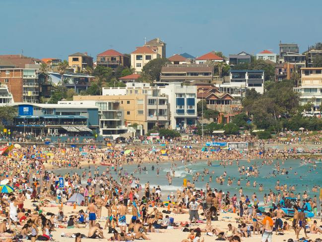 "Sydney, Australia - November 25, 2012: A large number of beach goers gather at the northern end of Bondi Beach on a hot Sunday afternoon." Australia crowds generic population