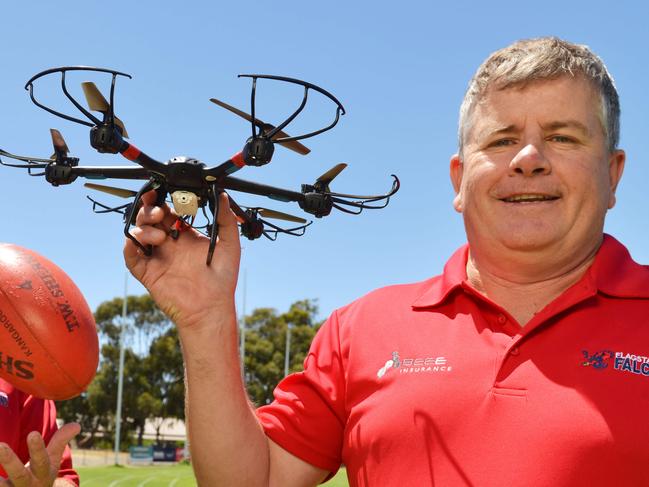 Flagstaff Hill footy club assistant coach Darren Vanzetta (L) and head coach Rod Mitchell with a drone, Saturday, February 3, 2018. The club is going for their third SFL premiership in a row this year and have started using drones at training.. (AAP Image/ Brenton Edwards)