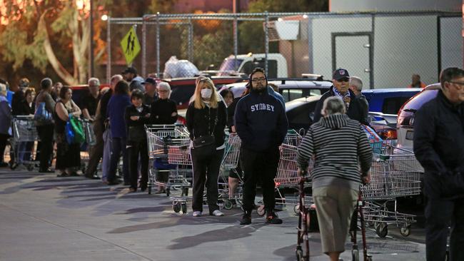 People line up outside a supermarket in Victoria. Picture: Mark Stewart